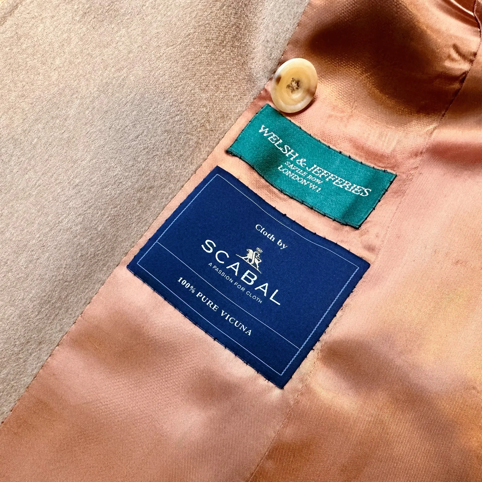 Interior lining detail inside camel vicuña belted wrap coat.