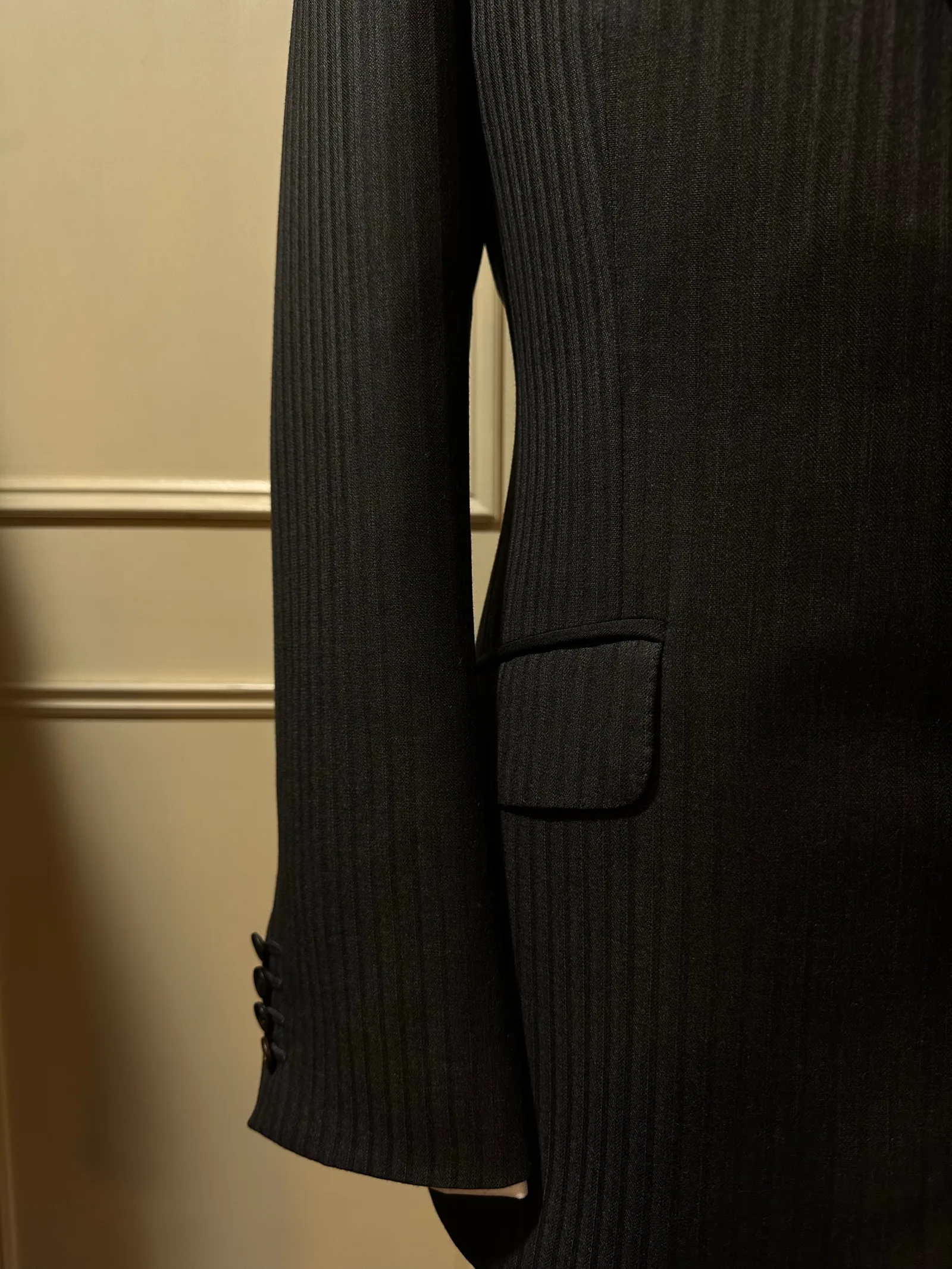 Close view of a charcoal shadow-stripe suit, highlighting shadow-stripe tailoring detail.
