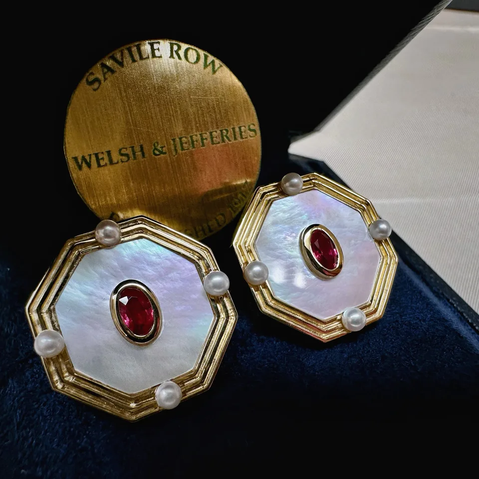 Octagonal gold cufflinks with luminous mother-of-pearl faces, oval rubies and pearls at four cardinal points.