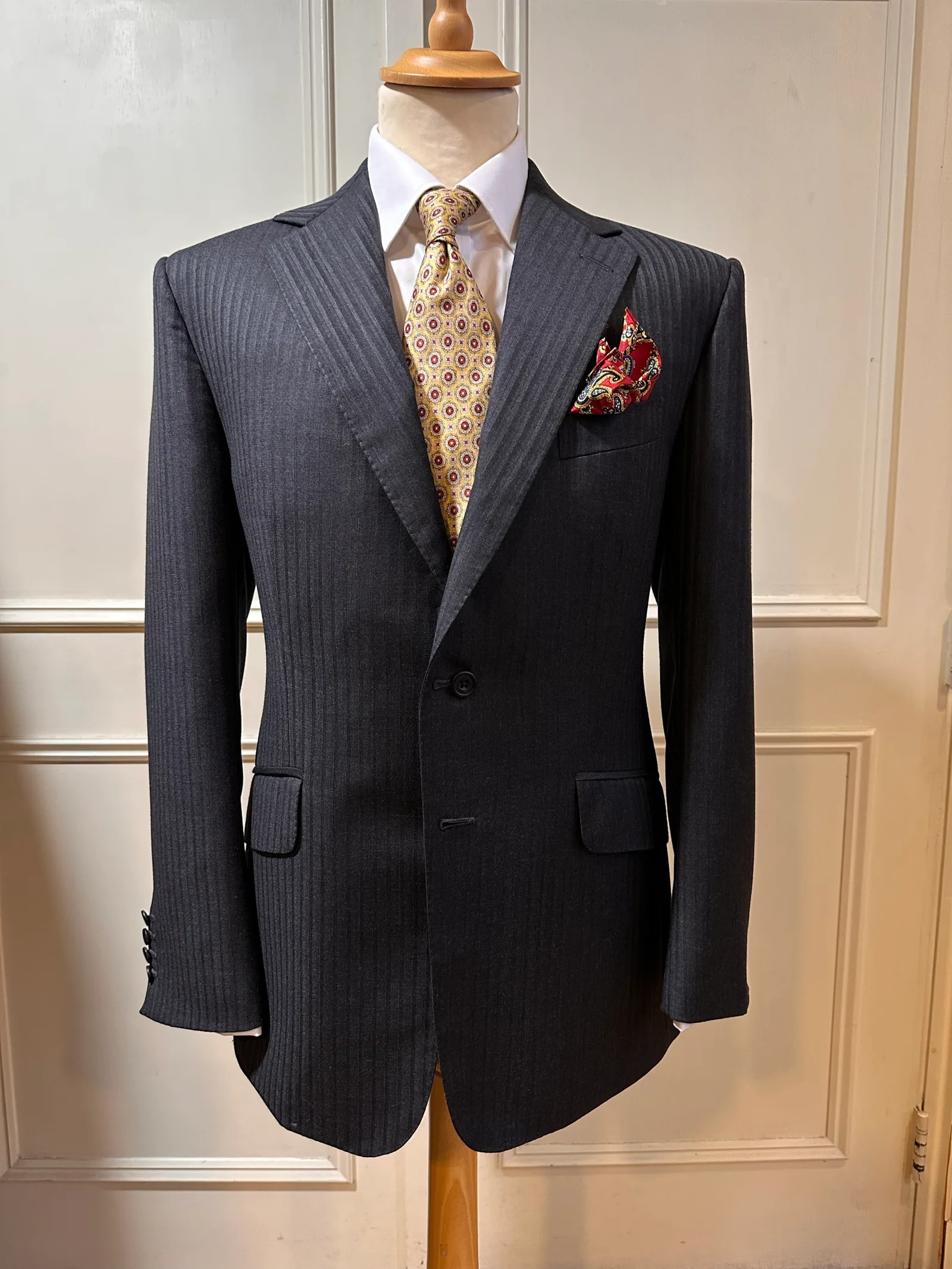 Close view of a charcoal shadow-stripe suit, highlighting shadow-stripe tailoring detail.