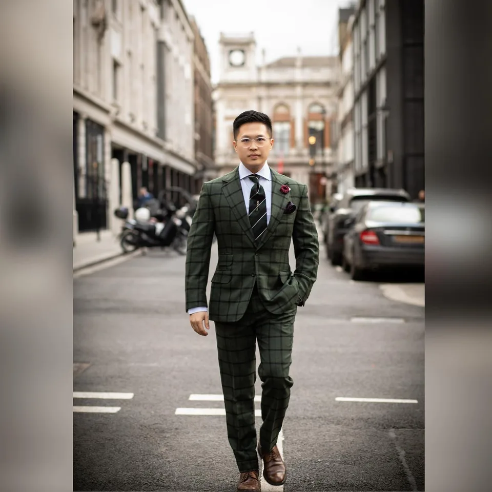 A gentleman walking in a forest-green windowpane suit on Savile Row.
