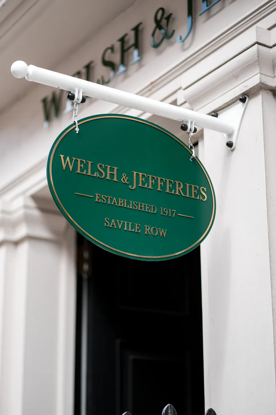 Welsh & Jefferies Savile Row sign hanging beside the white shop entrance