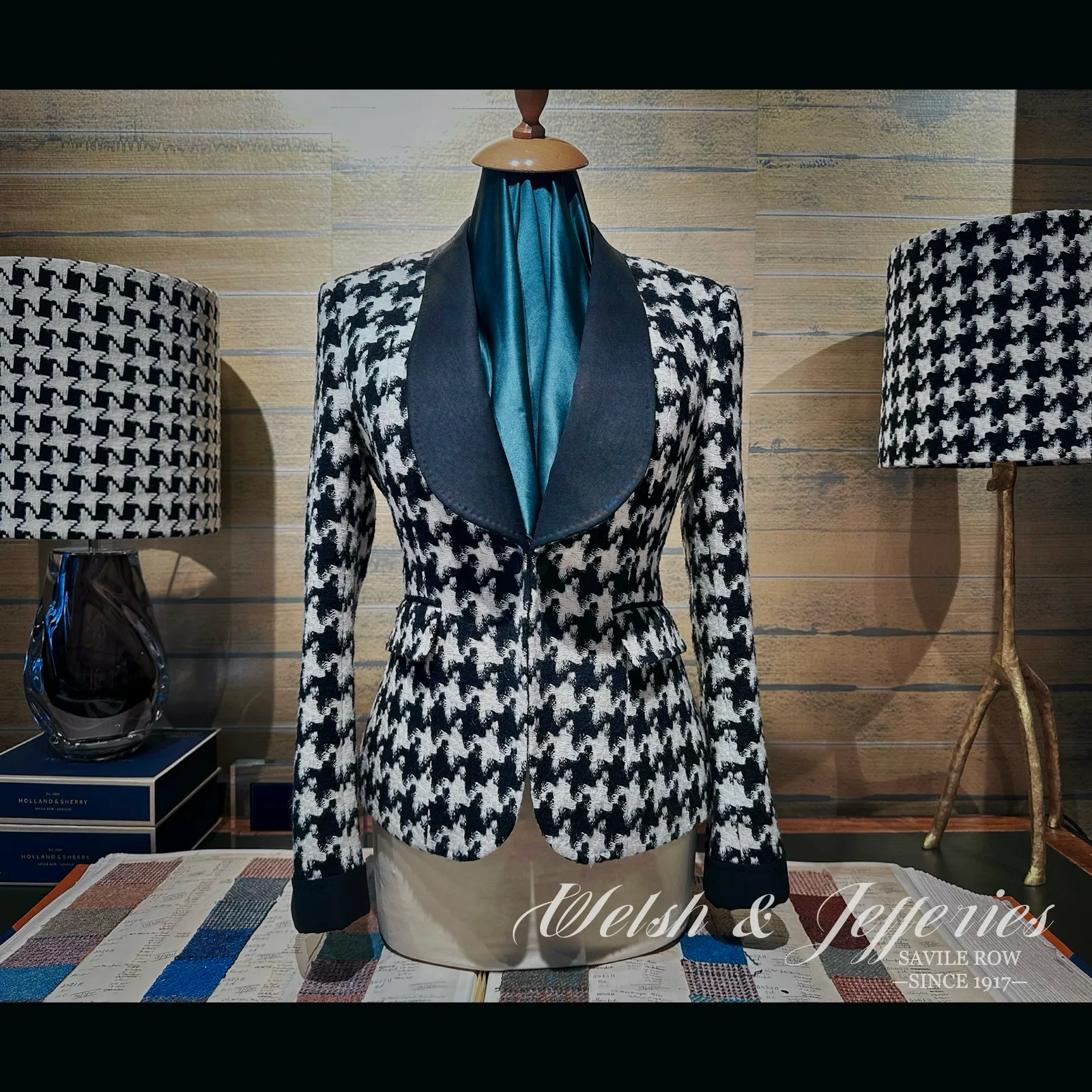 Front view of black-and-ivory houndstooth ladies' jacket with a black shawl collar.