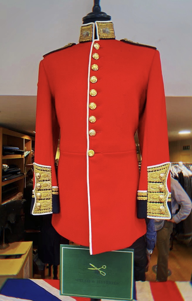 Scarlet ceremonial tunic with white piping, gilt buttons and broad gold-bullion cuff panels.