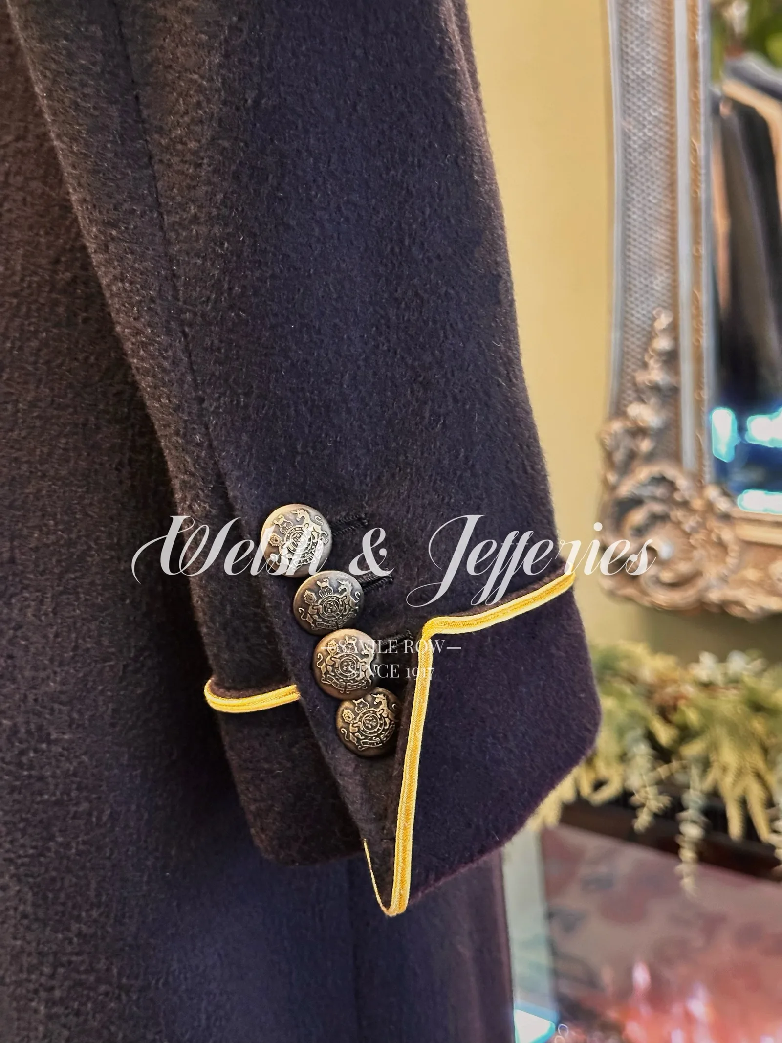 Front view of deep navy military coat with gold piping.