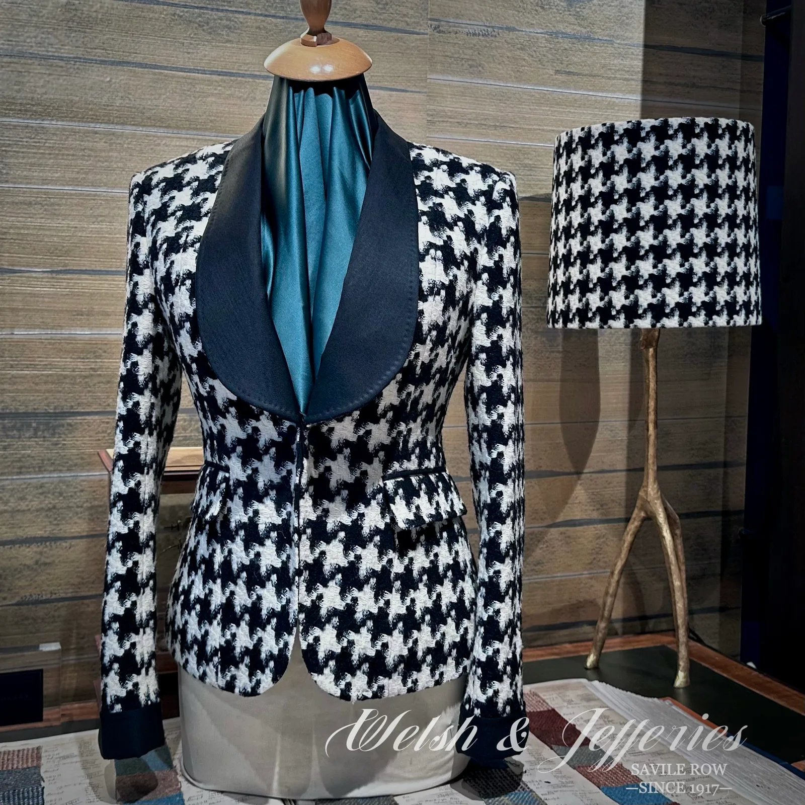 Front view of black-and-ivory houndstooth ladies' jacket with a black shawl collar.