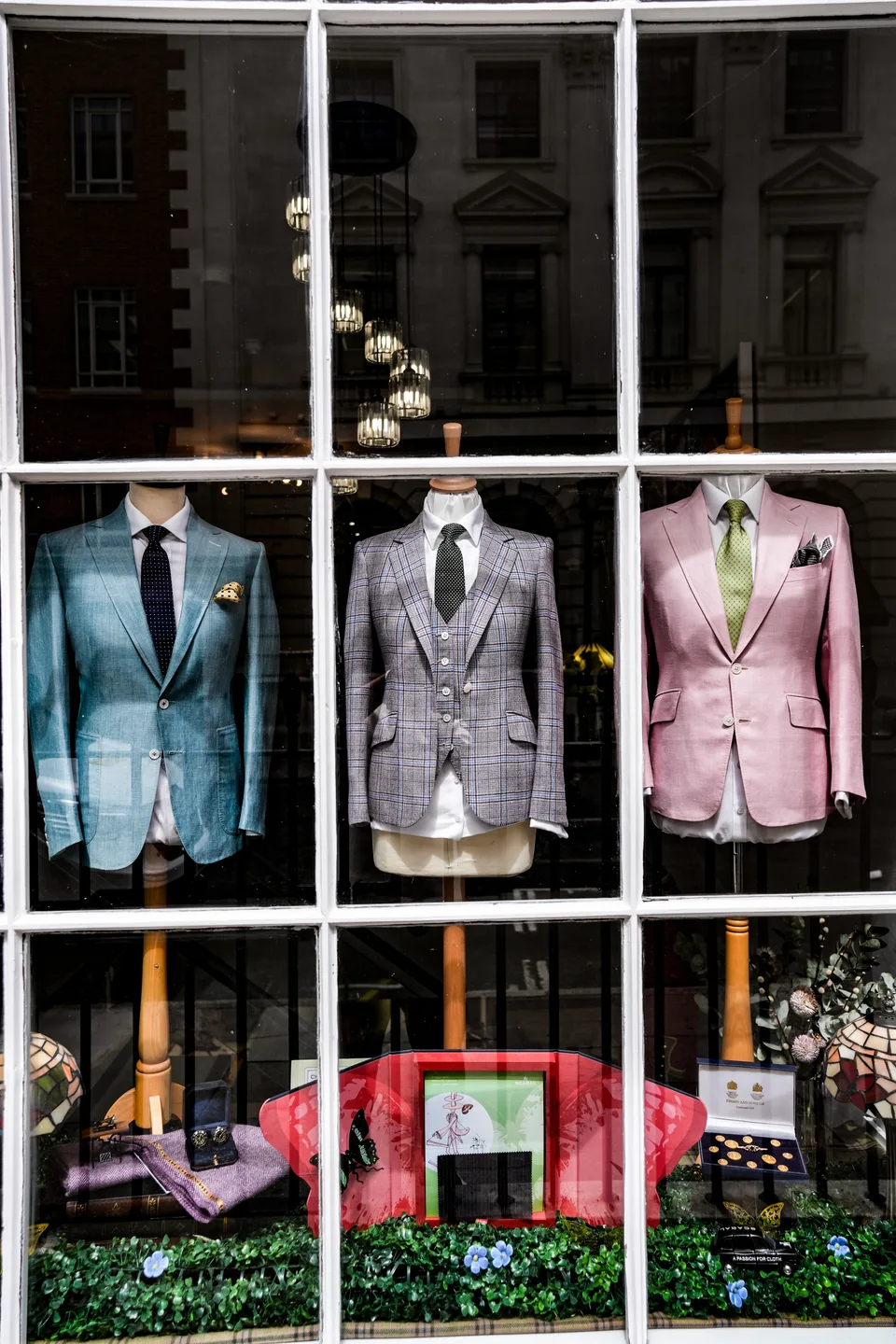 Three colourful bespoke jackets arranged in the Welsh & Jefferies window