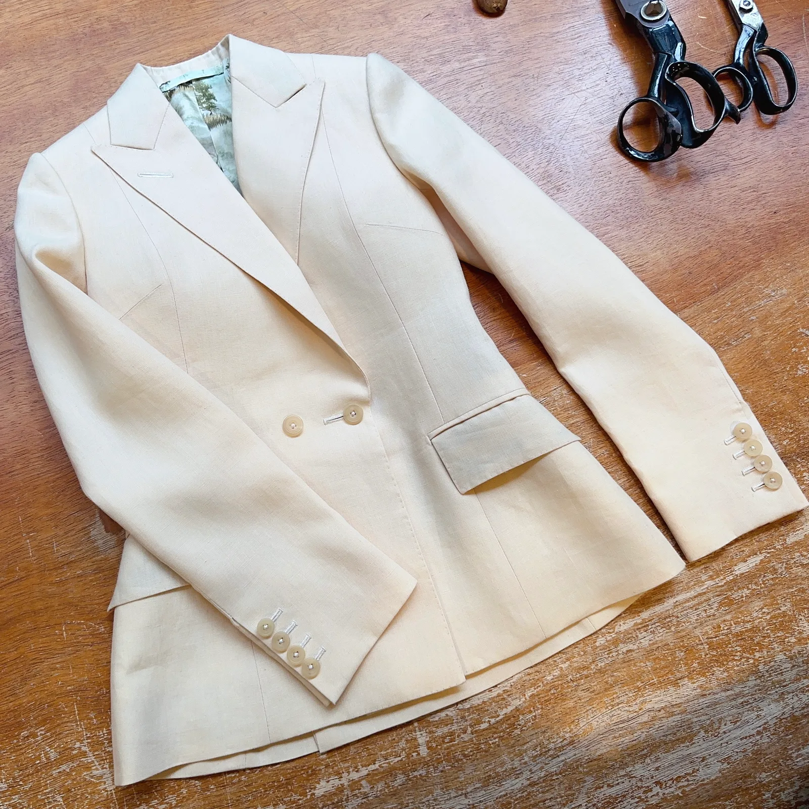 Laid-flat view of ivory basketweave ladies' jacket.