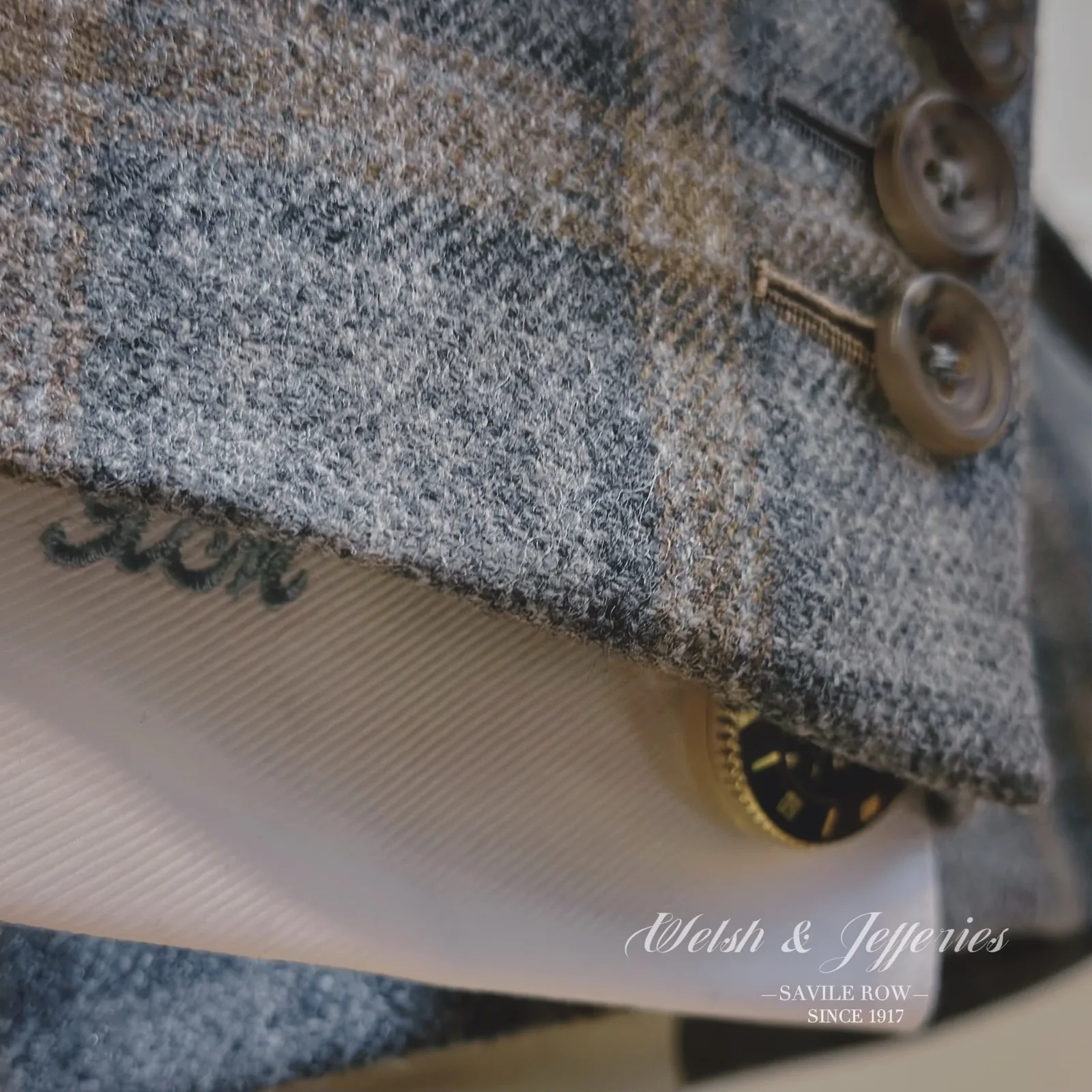 Cuff and sleeve detail on soft grey windowpane ladies' jacket.