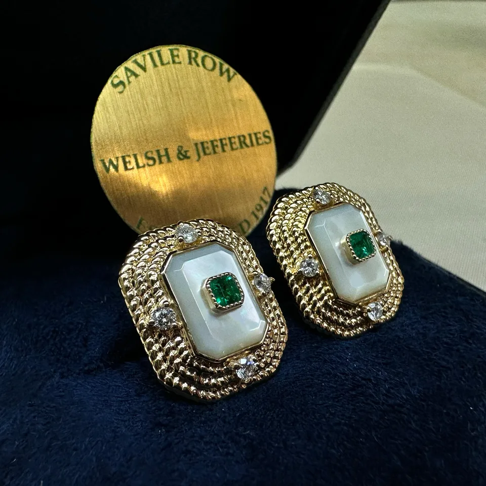 Pair of emerald and mother-of-pearl cufflinks framed in richly textured gold with four diamond accents.