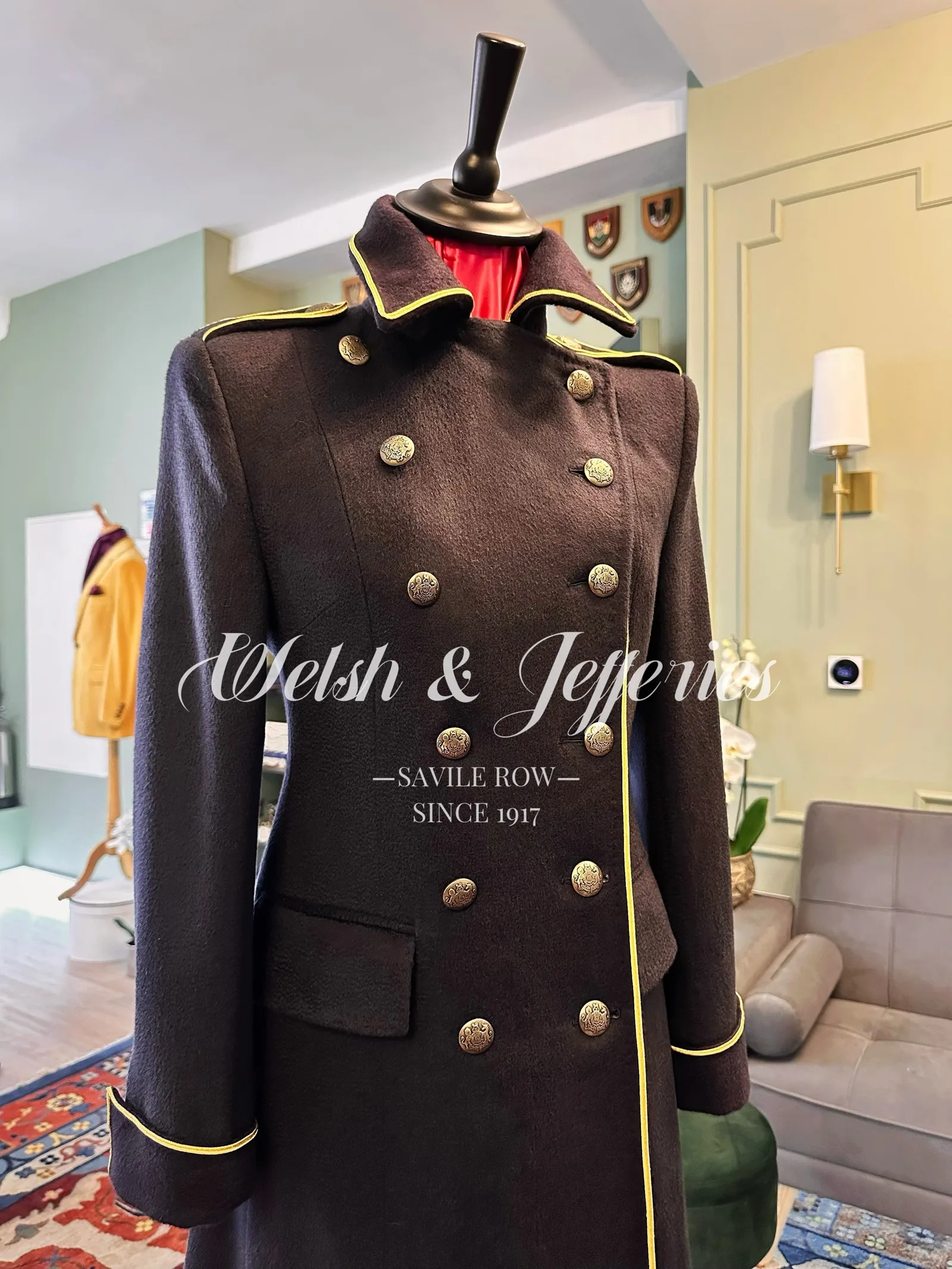 Cuff and sleeve detail on deep navy military coat with gold piping.