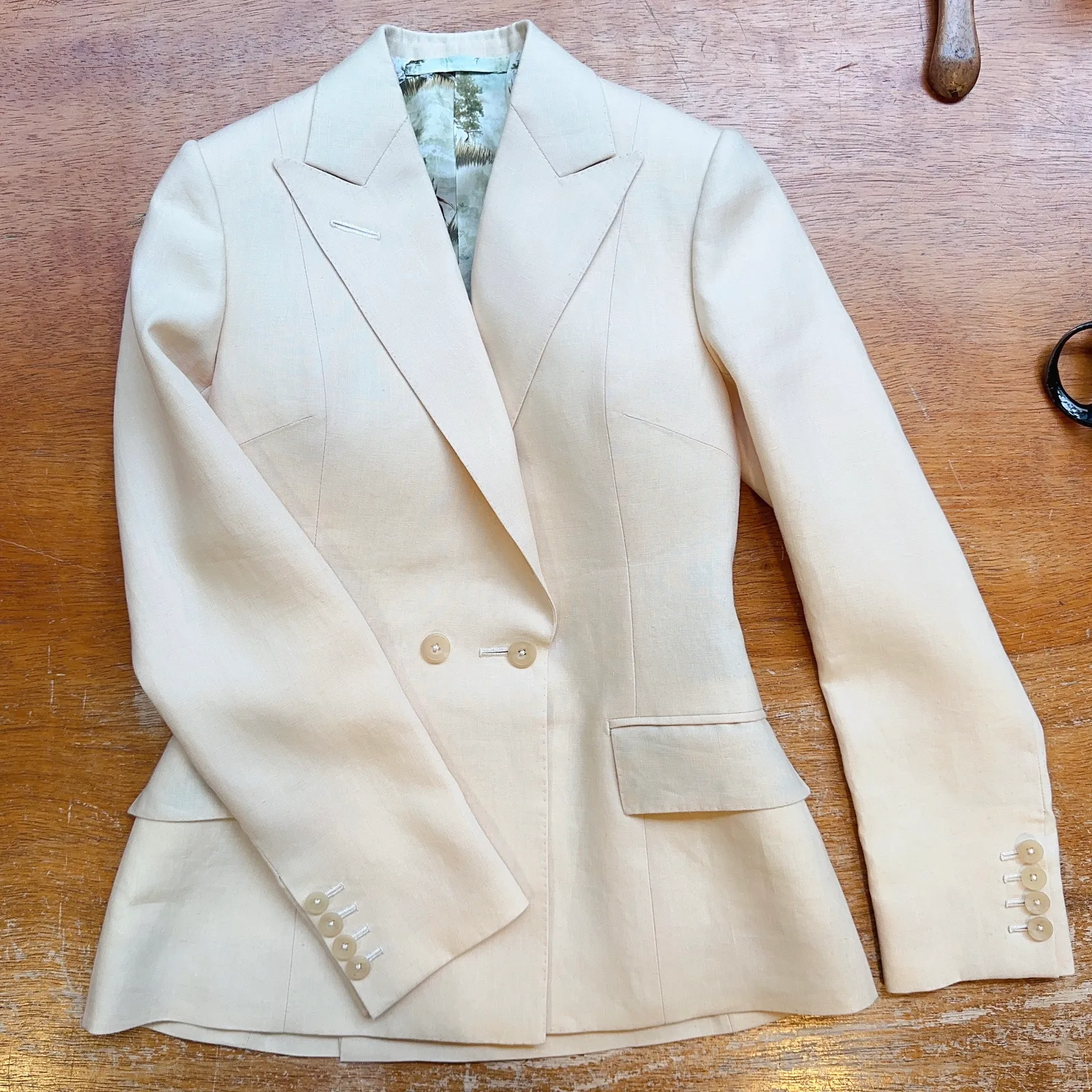 Laid-flat view of ivory basketweave ladies' jacket.