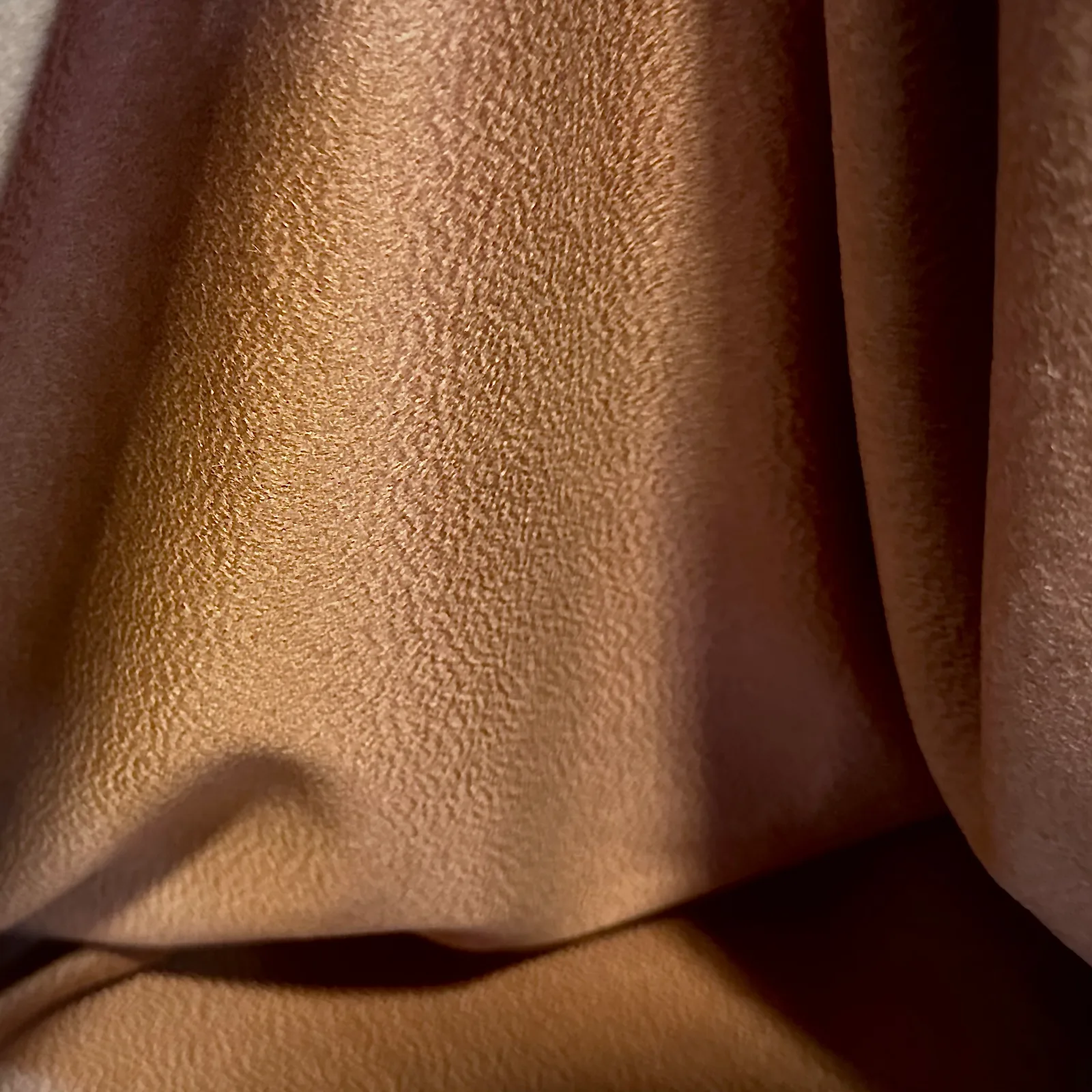 Close view of the cloth for camel vicuña belted wrap coat.