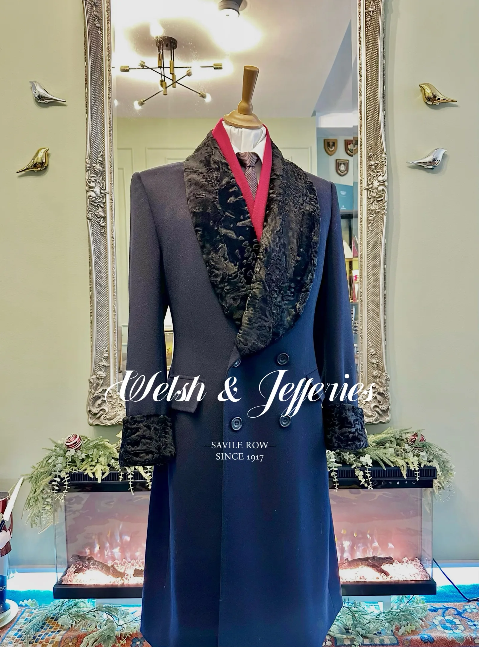Midnight cashmere evening coat with an enveloping black astrakhan-style collar and cuffs.
