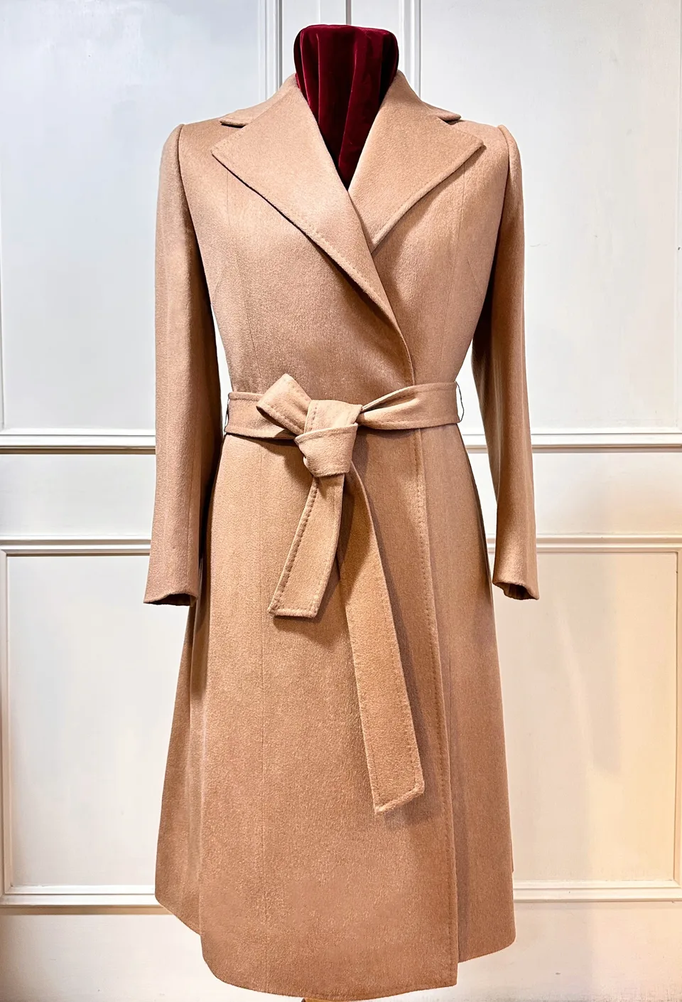 Front view of camel vicuña belted wrap coat.